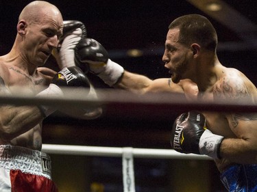 Lightweights Dave Aucoin of Brantford, Ont., left, and Mario Perez of Toronto, Ont., right, duke it out at the Teofista boxing series 15 in Calgary, on April 3, 2015. Perez won the bout.