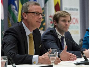 Saskatchewan Premier Brad Wall, left, speaks at a news conference marking the end of a summit on climate change, as New Brunswick Premier Brian Gallant looks on, Tuesday, April 14, 2015 in Quebec City.