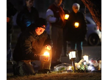 Calgarians attend a one year anniversary candle light vigil for the victims of the Brentwood murders in Calgary, on April 14, 2015.