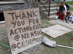 A sign thanks the city and police as residents and volunteers continue the arduous flood cleanup effort in Calgary's  Erlton neighbourhood on Tuesday June 25, 2013.