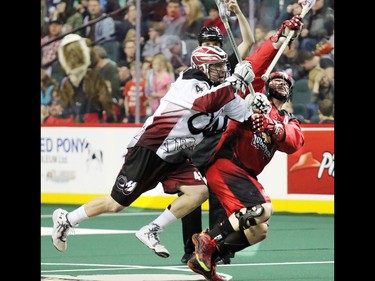 Gavin Young, Calgary Herald
The Calgary Roughnecks' Geoff Snider and Colorado Mammoth Bob Snider reach high for the ball during National Lacrosse League action at the Scotiabank Saddledome on Saturday April 4, 2015.