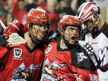 Calgary Roughnecks Curtis Dickson, left, and Shawn Evans celebrates after the Roughnecks scored on Colorado Mammoth goaltender Alex Buque during National Lacrosse League action at the Scotiabank Saddledome on Saturday April 4, 2015.