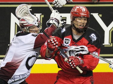 The Calgary Roughnecks' Curtis Manning and Colorado Mammoth Bob Snider crash together during National Lacrosse League action at the Scotiabank Saddledome on Saturday April 4, 2015.