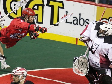 The Calgary Roughnecks' Curtis Dickson comes close in this scoring chance on Colorado Mammoth goaltender Alex Buque during National Lacrosse League action at the Scotiabank Saddledome on Saturday April 4, 2015.