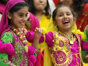 Young dancers laugh as they wait to perform in the Vaisaki Mela Festival at the Genesis Centre in northeast Calgary on Saturday April 4, 2015.