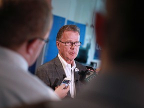 Education Minister Gordon Dirks speaks with the media at his Calgary-Elbow campaign headquarters as he responds to criticism from trustees of 19 Alberta school districts over funding cuts in the new provincial budget.