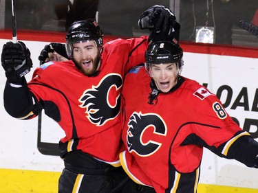 TJ Brodie and Joe Colborne celebrate Sam Bennett's goal the third against the Canucks during the first period of NHL playoff  game 4 action at the Scotiabank Saddledome.