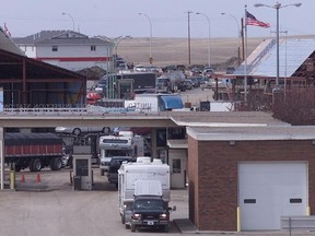 Cars and trucks line up and wait at the Coutts, Alta. border crossing.