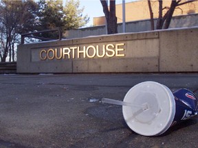 Calgary-11/12/03-A discarded slush cup clutters the sidewalk outside the Red Deer Courthouse after 3 girls, who poisoned a shared slushie drink with copper sulphate in April 2003, were sentenced to 60 days in a young offenders centre and additional confinement and parole .  There were seven victims who were treated for poisioning. Photo by Jenelle Schneider/Calgary Herald  * Calgary Herald Merlin Archive *