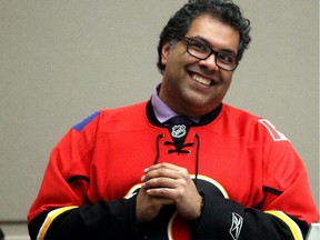 Wearing his Calgary Flames playoff jersey, Mayor Naheed Nenshi enjoys a lighter moment during city council on April 13.