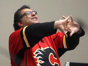 Wearing his Calgary Flames playoff jersey Mayor Naheed Nenshi enjoys a lighter moment during the city council debate on council seating arrangements Monday April 13, 2015.