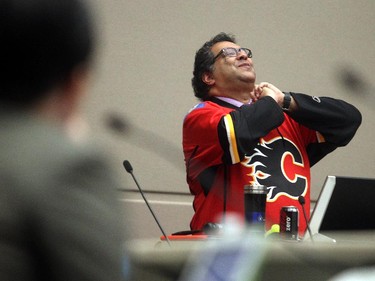 Wearing his Calgary Flames playoff jersey Mayor Naheed Nenshi enjoys a lighter moment during the city council debate on council seating arrangements Monday April 13, 2015.