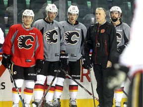 Calgary Flames head coach Bob Hartley stands with players, from left, Jiri Hudler, Cory Potter, Tyler Wotherspoon and David Schlemko during practice on Tuesday.