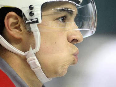 Johnny Gaudreau of the Calgary Flames watches from bench during practice Tuesday April 14, 2015. Potential playoff beard, or lack thereof, feature.