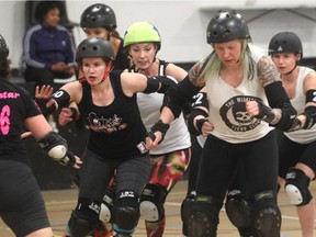 Members of the All Star Team with the Calgary Roller Derby Association, including Front Page Bruise, left, and Scarlett Maim, battle for position during a scrimmage Thursday April 16, 2015. The team is going to South Carolina next week for Southern Discomfort tournament.