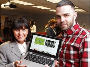 Lucy Miller, president and CEO of the United Way of Calgary, holds a laptop with the new YYC Connects website alongside site designer Geoff Hughes on April 27, 2015.
