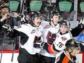 Calgary Hitmen captain Kenton Helgesen, left, celebrates a goal on the Medicine Hat Tigers with teammates Adam Tambellini and Connor Rankin during Game 3 at the Scotiabank Saddledome. The Hitmen won 5-4 to take a 2-1 series lead.