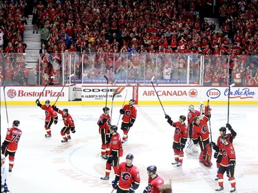 Calgary Flames players salute the 'C' of Red after eliminating the Canucks on Saturday night.
