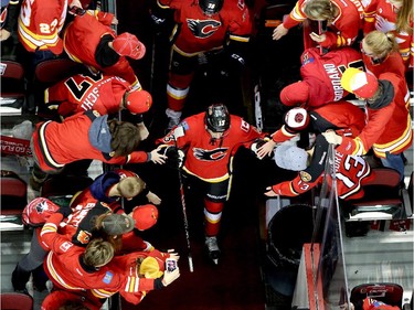 Calgary Flames Johnny Gaudreau greets fans as they take the ice against the Vancouver Canucks during game 6 of the NHL Playoffs at the Scotiabank Saddledome in Calgary.