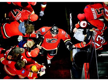 Calgary Flames Matt Stajan, left, hits the ice during warmup before they take on the Vancouver Canucks during game 6 of the NHL Playoffs at the scotiabank Saddledome in Calgary.