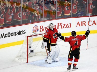Calgary Flames netminder Karri Ramo, left and defenceman Kris Russell right, celebrate their win against the Vancouver Canucks.