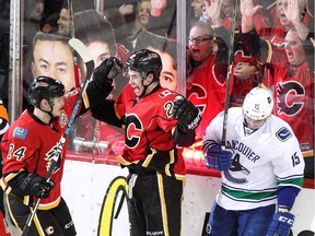 Calgary Flame Sean Monahan, middle, celebrates his goal on the Vancouver Canucks with teammate Jiri Hudler during Game 6 of the NHL playoffs. Reader says Hudler is doing a fantastic job for the Flames.