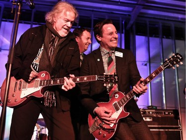 Andrew Mosker, president and CEO National Music Centre, middle, jams with Randy Bachman on the guitar Bachman recorded American Women with during the National Music Centre and Bell announcement.