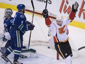 Calgary Flames centre Matt Stajan celebrates teammate David Jones' goal past Vancouver Canucks goalie Eddie Lack during the third period of Game 1 on Wednesday night. Kris Russell scored late as the Flames won 2-1.