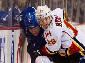 Calgary Flames' Matt Stajan pins Vancouver Canucks' Derek Dorsett along the side boards during a game in Vancouver in January. The Flames tied a franchise record with 22 road wins this season.