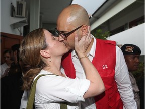 Canadian teacher Neil Bantleman kisses his wife Tracy prior to the verdict being delivered in his trial at South Jakarta District Court in Jakarta, Indonesia, Thursday, April 2, 2015.