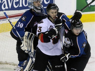 Christina Ryan/ Calgary Herald CALGARY, AB --APRIL 3, 2015 -- The Calgary Hitmen Taylor Sanheim takes a hit from Kootenay Ice Troy Murray in the opening round of the Western Hockey League playoff series at the Scotiabank Saddledome in Calgary on April 3, 2015. (Christina Ryan/Calgary Herald) (For Sports story by Christina Ryan) 00063969A SLUG: 0404 Hitmen vs. Kootenay 13