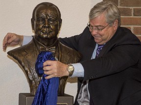 Rick Matthews, son of the late Dick Matthews, whose donation helped fund a bust of Churchill, unveils the piece for the first time to the public at its permanent location at Sir Winston Churchill High School in Calgary, on April 2, 2015. The renowned Canadian sculptor, Peter Sawatzky, was not present for the unveiling.