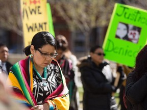 Cheryle Greyeyes-Chagnon, left, takes a moment of silence along with other protestors in memory of Cindy Gladue in Calgary on Thursday, April 2, 2015.