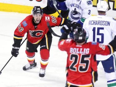 Calgary Flames centre Josh Jooris, left, turned to teammate left winger Brandon Bollig after Bollig scored the first goal of the game against the Vancouver Canucks during first period NHL Game 3 playoff action at the Scotiabank Saddledome in Calgary on April 19, 2015.