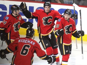 Calgary Flames left winger Johnny Gaudreau, right, celebrates a first-period goal with teammates, from left, centre Jiri Hudler, defenceman Dennis Wideman, and centre Sean Monahan in Game 4 on Tuesday.
