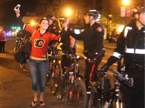 Kelsey Hansen ran up and down the police line giving high fives to officers as people spilled out onto 17th Avenue S.W. to celebrate the Flames' Game 4 win over the Vancouver Canucks.