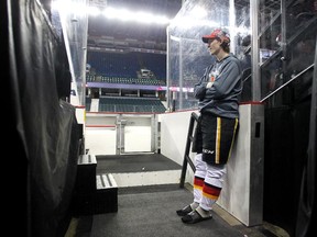 Suited up and ready to go, Calgary Flames prospect defenceman Ryan Culkin watches practice from the visitors bench tunnel as the main team skated earlier this week. He's gaining experience as a black ace.