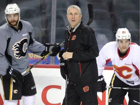 Calgary Flames head coach Bob Hartley kept an eye on the drills as the team skated during practice