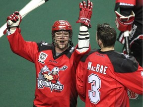 Calgary Roughnecks players Dane Dobbie, left, and Dan MacRae celebrated after posting their first win of the season against the Vancouver Stealth in National Lacrosse League action at the Scotiabank Saddledome on February 21, 2015. The Roughnecks broke their winless season with a 16-13 win over Vancouver.