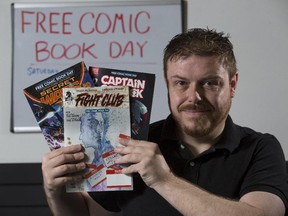 Chris Humphries, owner Alpha Comics, displays some of the comics that he will he will be giving away on Free Comic Book Day, Saturday, May 2, 2015.