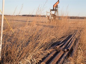 An idled pump jack sits rusting above a well in a farmers field. Landowners in Alberta are complaining that oil and gas producers are unfairly reducing surface rent payments.