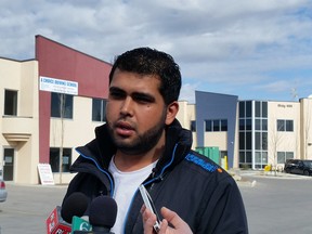 Qamar Maqsood, the son of 2014 homicide victim Maqsood Ahmed, speaks to media on April 21, 2015 outside the NE store where his father was killed.
