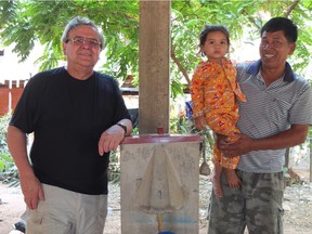 David Manz visiting recently with Theng Harn and his granddaughter. Harn, in 1999, received Samaritan's Purse Canada's first-ever BioSand Water Filter in Cambodia. Sixteen years later, the filter is still providing safe water every day.