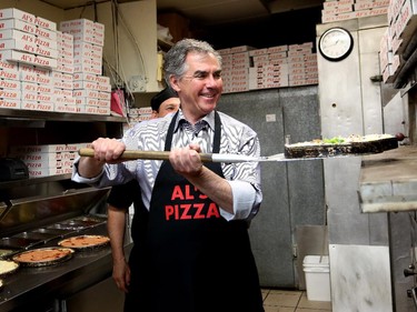Premier Jim Prentice makes pizza at Al's Pizza in Calgary on April 29, 2015.