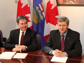 In this file photo, Prime Minister Stephen Harper is photographed with  Jim Prentice in Calgary in 2009.