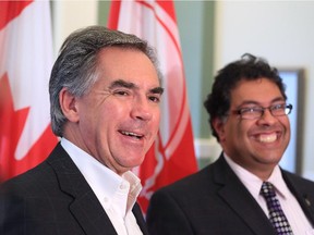 Premier Jim Prentice and Calgary Mayor Naheed Nenshi share a laugh while talking with the media after meeting at Calgary's City Hall on Tuesday September 9, 2014.