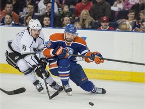 Luke Gazdic of the Edmonton Oilers battles Drew Doughty of the Los Angeles Kings on Tuesday night. The Kings lost 4-2, meaning they have to beat the Calgary Flames on Thursday night at the Scotiabank Saddledome to have any chance of making the playoffs.