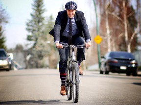 Alberta Party Leader Greg Clark rides his bike after attending an Earth Day concert at his daughter's school in Calgary.