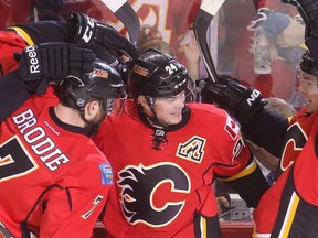 Calgary Flames players cheer after their second goal of the first period at the Scotiabank Saddledome in Calgary on Thursday, April 9, 2015. The Calgary Flames lead the Los Angeles Kings, 2-0, at the end of the first period in regular season NHL play.