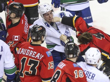 Calgary Flames Kris Russell throws a punch at Vancouver Canucks Alexandre Burrows as others duke it out around them during one of the many fist fights at game three of the playoffs at the Saddledome in Calgary, on April 19, 2015.